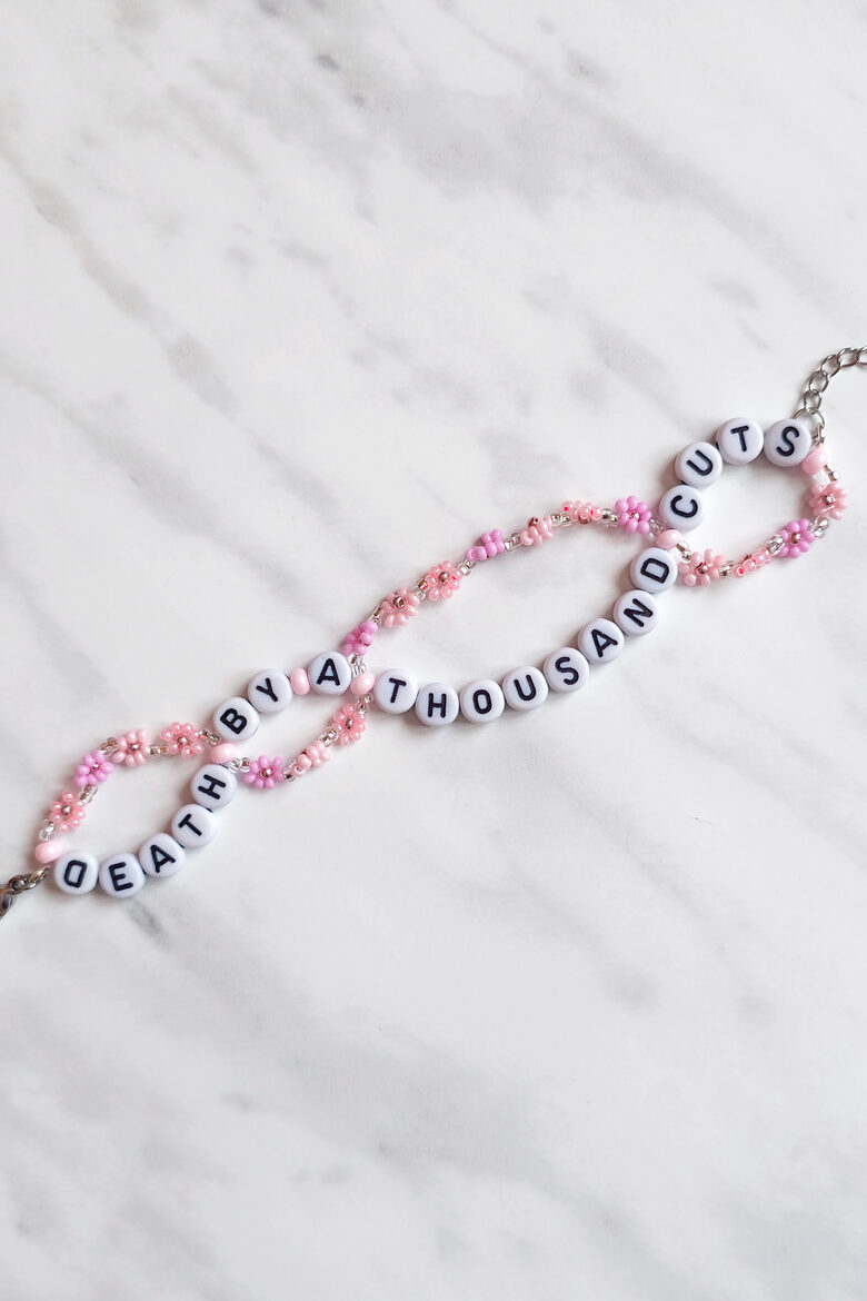 Death By A Thousand Cuts Bracelet with upside down letter D